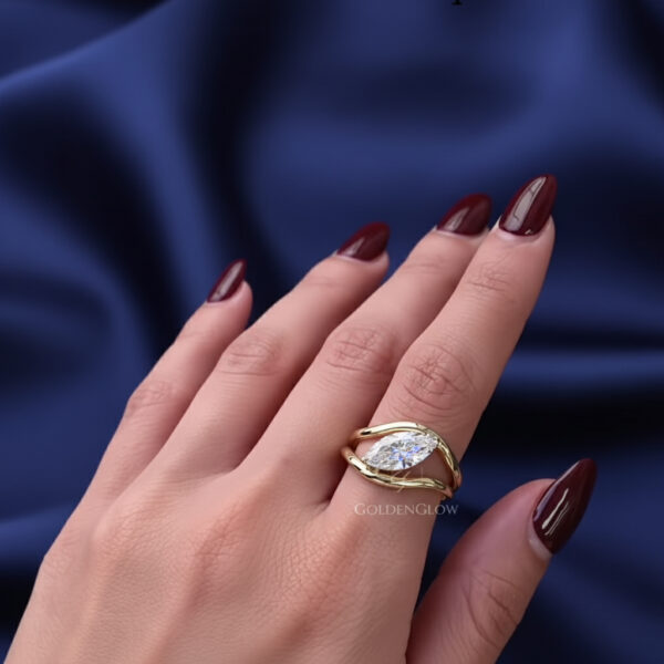 oval solitaire ring, marquise cut diamond, bypass engagement ring, modern gold ring, yellow gold ring, unique engagement ring, minimalist solitaire ring, contemporary bridal ring, lab grown diamond ring, moissanite ring, fine jewelry, luxury ring, anniversary ring, wedding ring, custom made ring, modern bride ring
